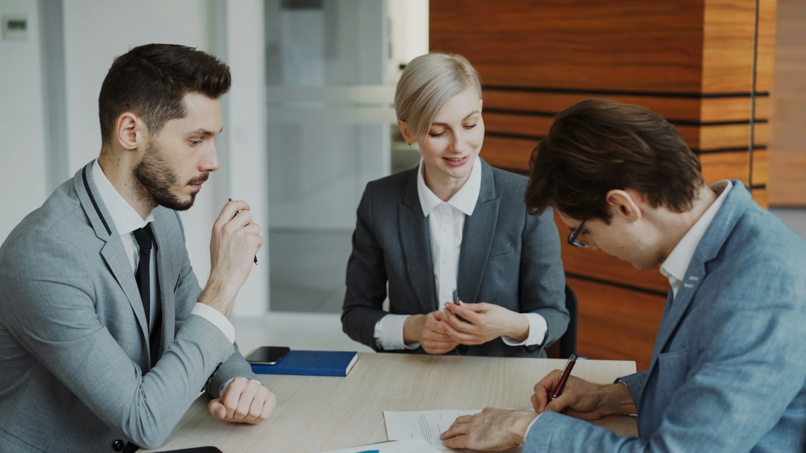 Attorneys reviewing a document with a client during a consultation